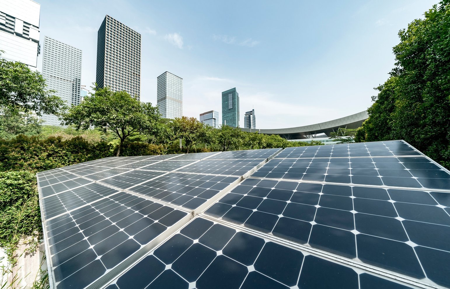 Solar panels with a green city skyline