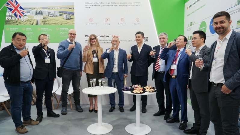 DX Energy team and partners celebrating at the DX Energy booth during Intersolar Europe 2025